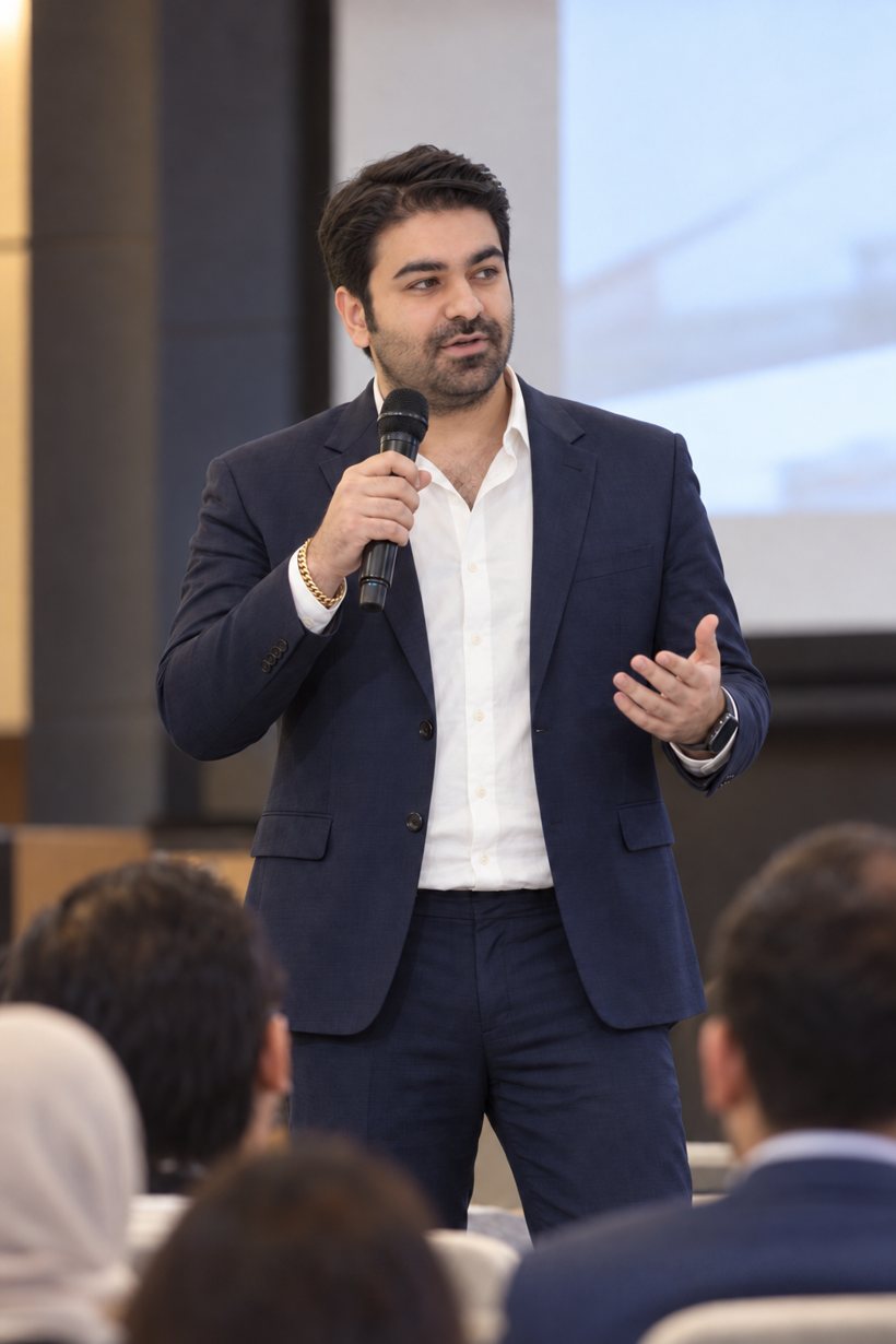 Sepehr Parsa speaking with a microphone in Toronto